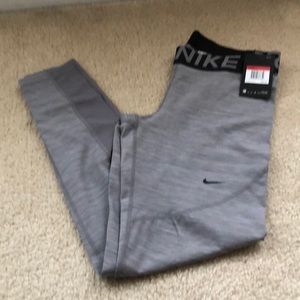 Nike exercise pants in Frey with lower mesh sides.